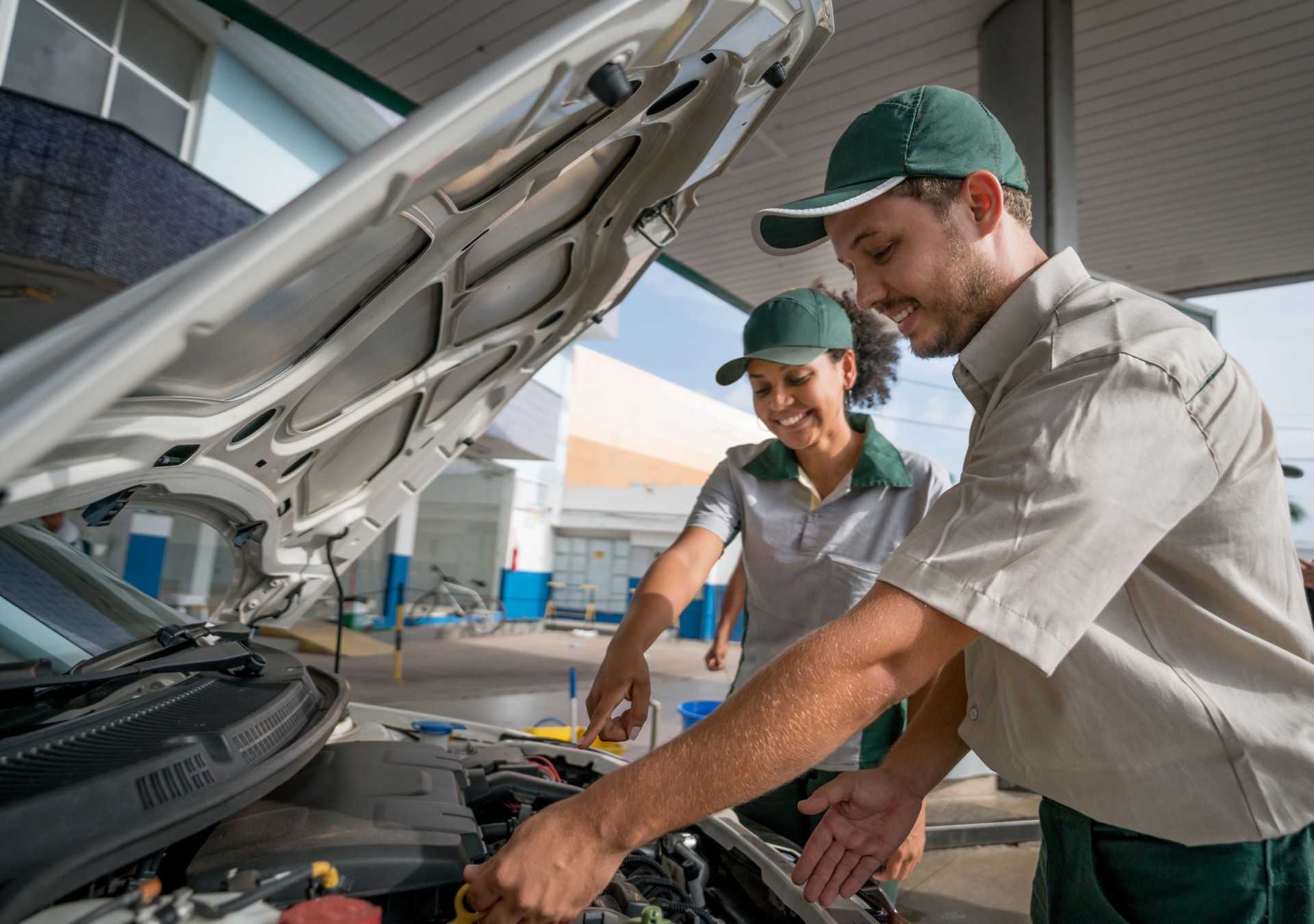 Happy mechanics working at a service station