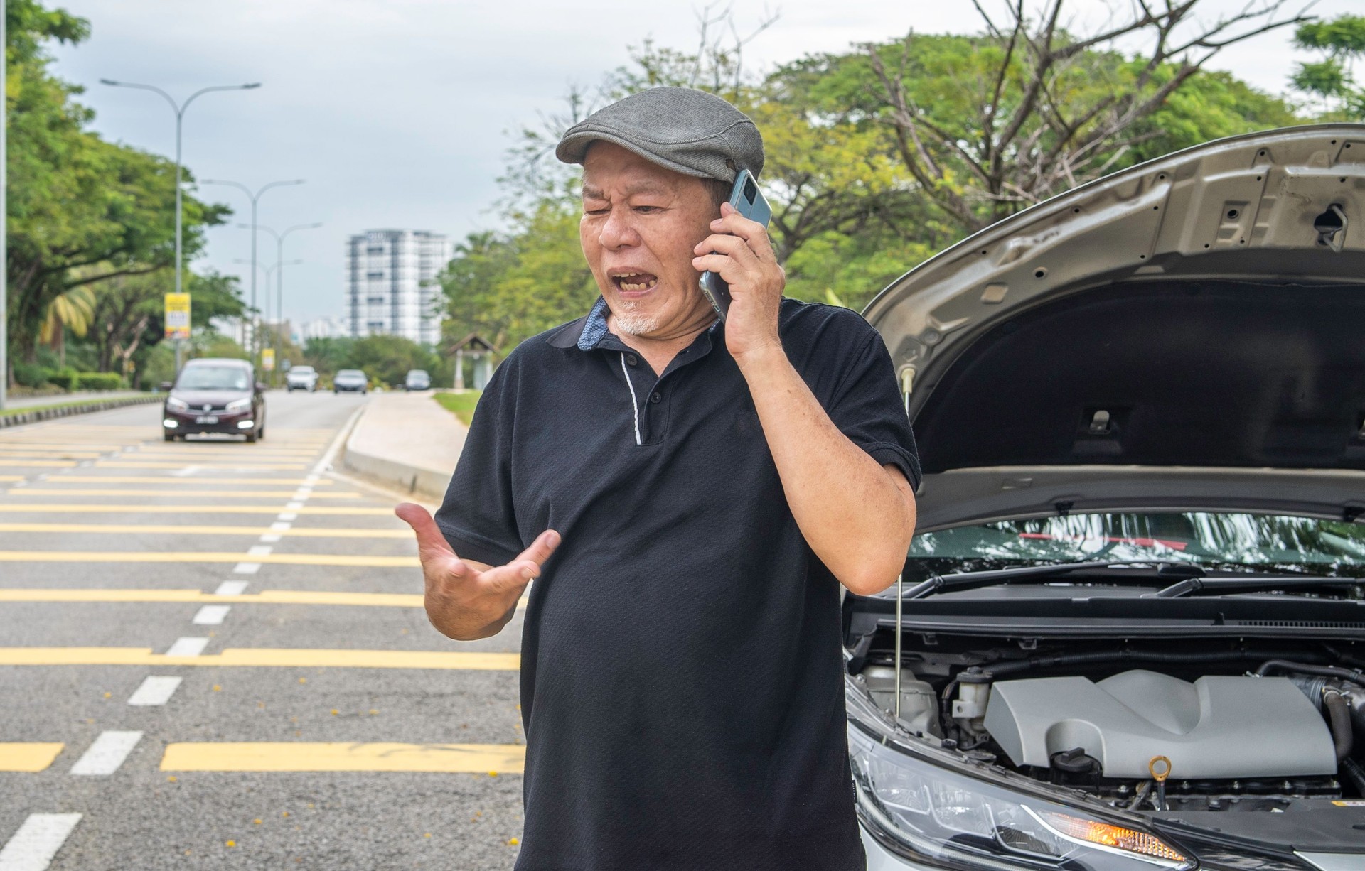 Senior driver man with car breakdown and  on phone for roadside assistance